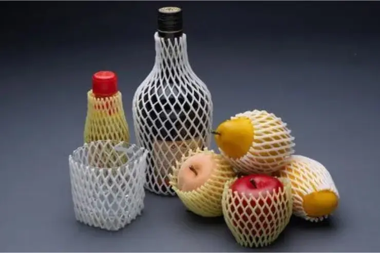 Protective foam net sleeves covering fruits, a glass bottle, and containers for cushioning and safe packaging.
